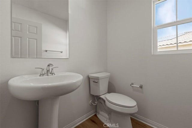 bathroom featuring hardwood / wood-style flooring and toilet