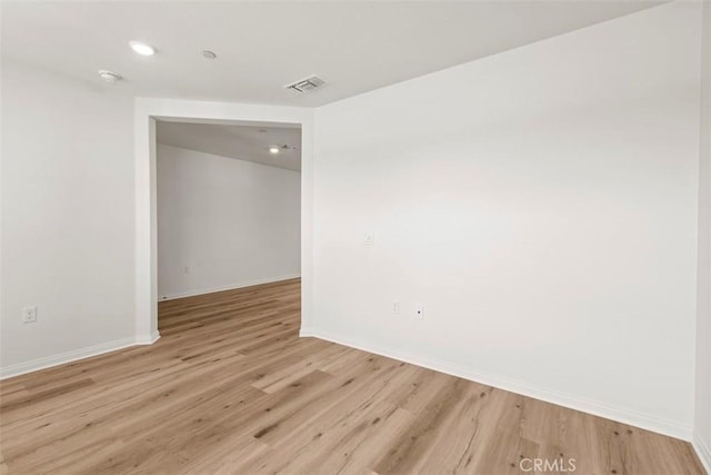 spare room with light hardwood / wood-style flooring