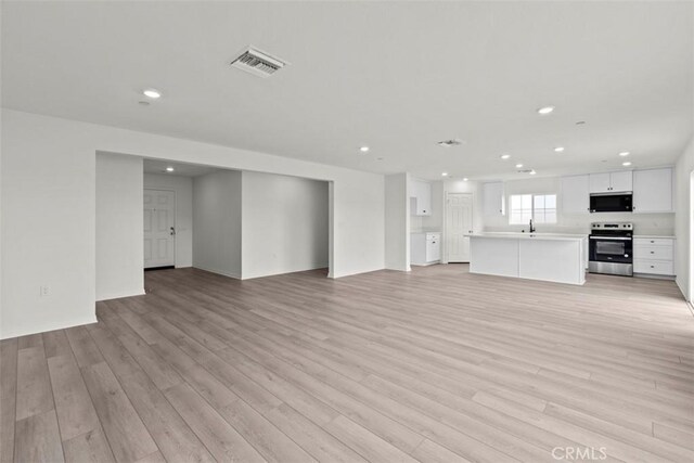 unfurnished living room with light hardwood / wood-style flooring