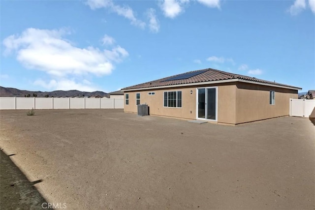 back of house featuring central air condition unit and a patio area