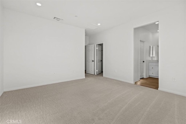 unfurnished room with light carpet