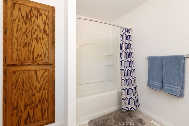 bathroom with shower / tub combo with curtain and tile patterned flooring