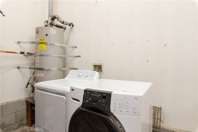 clothes washing area with secured water heater and separate washer and dryer