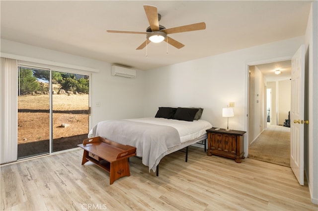 bedroom with light hardwood / wood-style floors, ceiling fan, access to outside, and a wall mounted air conditioner