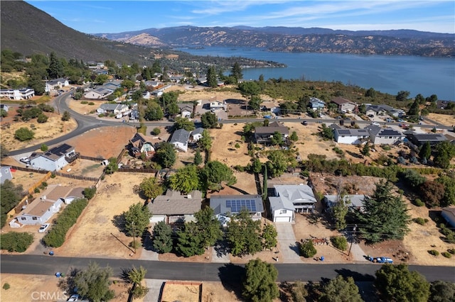 drone / aerial view with a water and mountain view