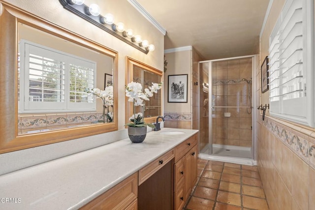 bathroom featuring vanity, a shower with shower door, and tile walls