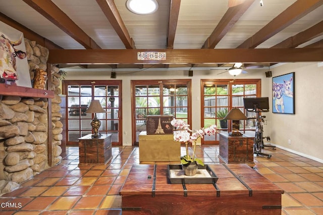 living room with beamed ceiling, ceiling fan, and tile patterned flooring