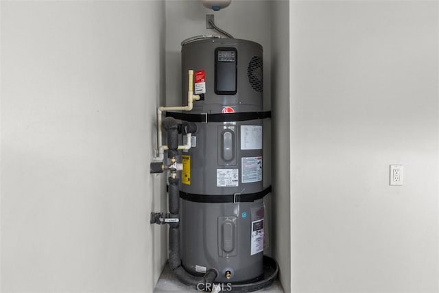 utility room featuring strapped water heater