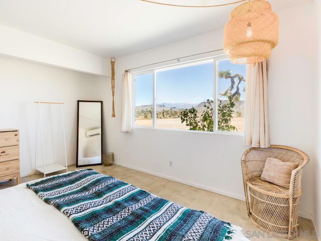 bedroom featuring light carpet and a mountain view