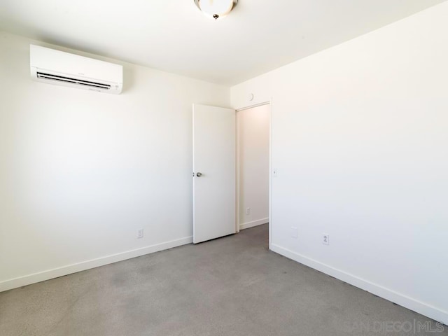 spare room with an AC wall unit