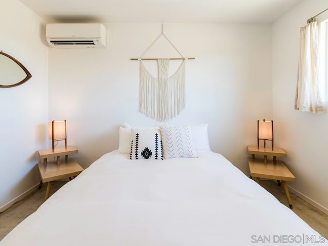 bedroom featuring carpet flooring and a wall mounted air conditioner