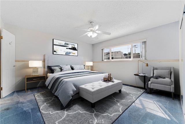 carpeted bedroom with ceiling fan and a textured ceiling