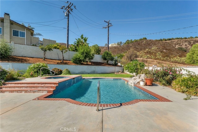 view of swimming pool featuring an in ground hot tub and a patio area