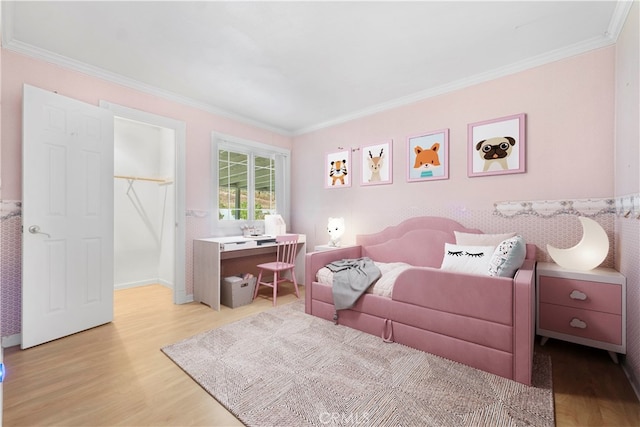 bedroom featuring ornamental molding and light hardwood / wood-style floors