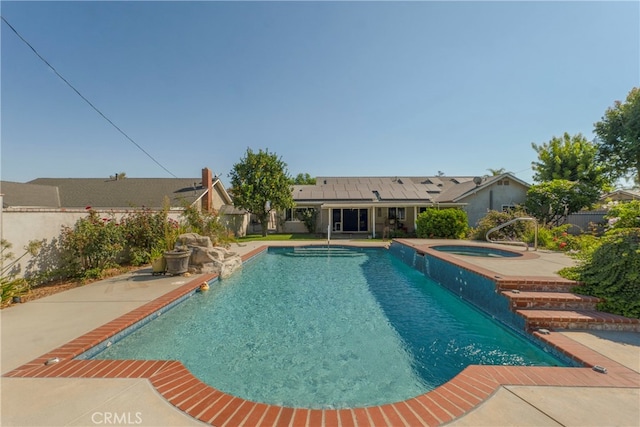 view of pool with a patio and an in ground hot tub