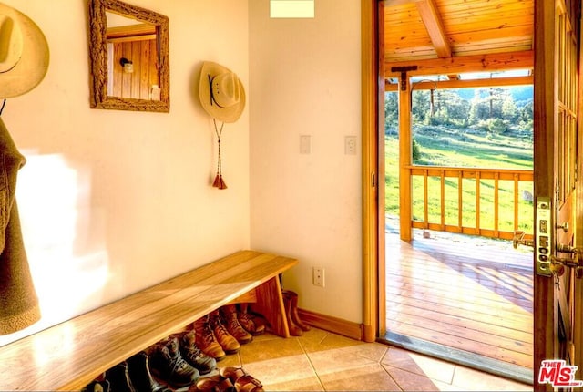 entryway featuring wooden ceiling and light tile patterned floors