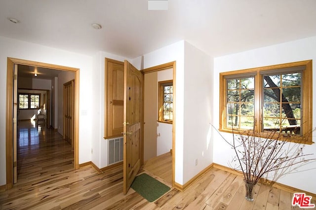 corridor featuring wood-type flooring