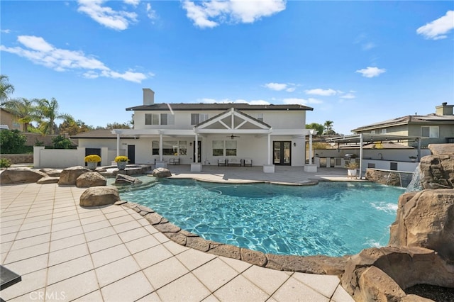 view of pool featuring pool water feature, ceiling fan, and a patio area