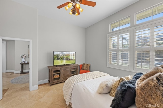 tiled bedroom featuring ceiling fan