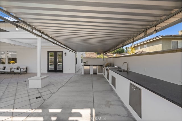 view of patio with a grill, area for grilling, and sink