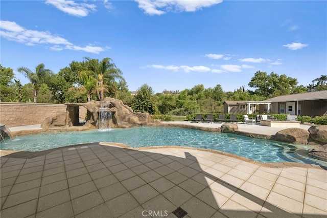 view of pool featuring pool water feature and a patio area