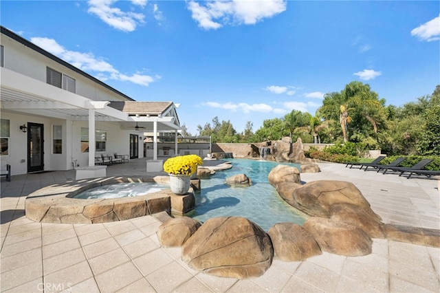 view of pool with an in ground hot tub, a pergola, pool water feature, and a patio area