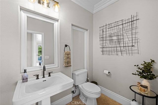 bathroom featuring crown molding, sink, tile patterned floors, and toilet