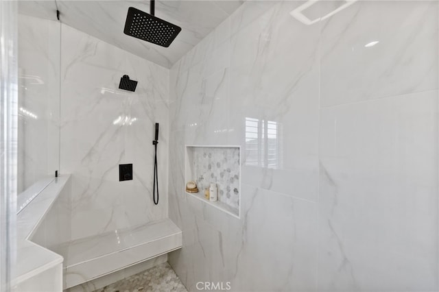 bathroom featuring a tile shower