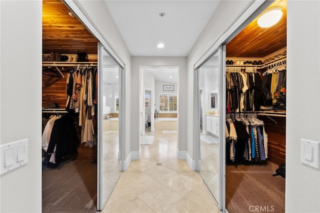 walk in closet featuring light tile patterned flooring