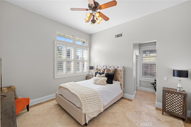 bedroom with ceiling fan and light tile patterned flooring