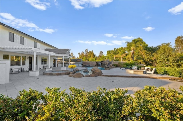 view of swimming pool featuring an in ground hot tub, an outdoor fire pit, a pergola, and a patio area