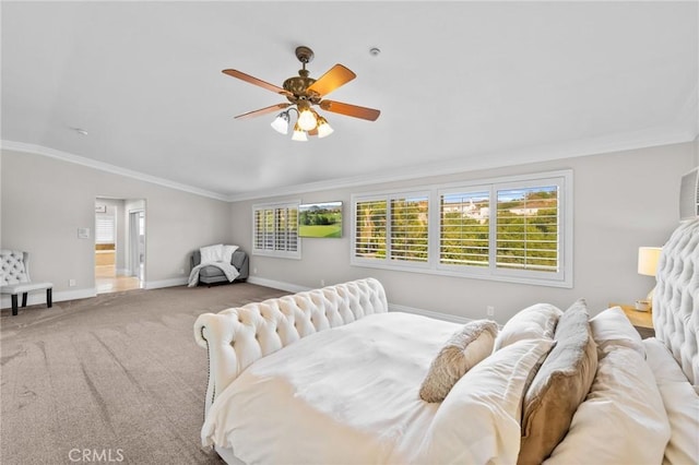 carpeted bedroom with lofted ceiling, ornamental molding, and ceiling fan