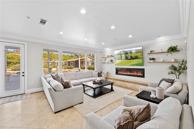 tiled living room featuring ornamental molding and plenty of natural light