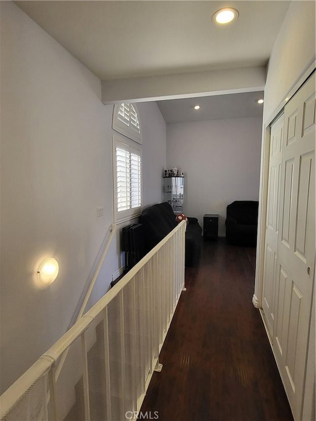 corridor with beam ceiling and dark hardwood / wood-style flooring