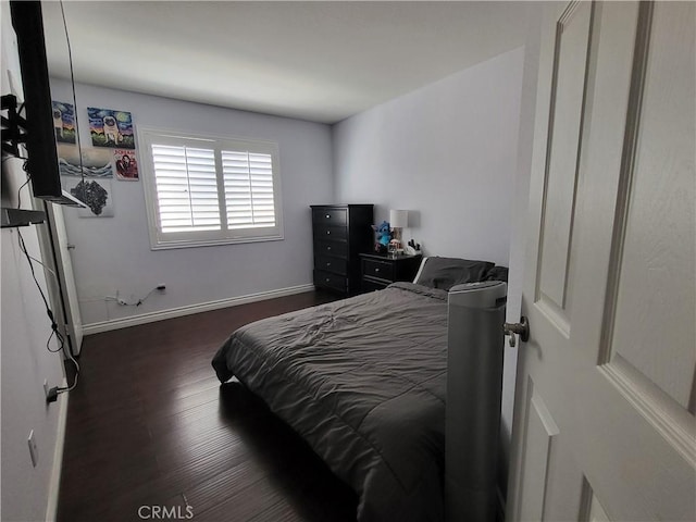 bedroom featuring dark hardwood / wood-style flooring