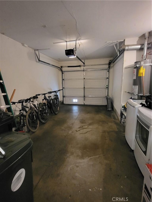 garage featuring washing machine and dryer, water heater, and a garage door opener