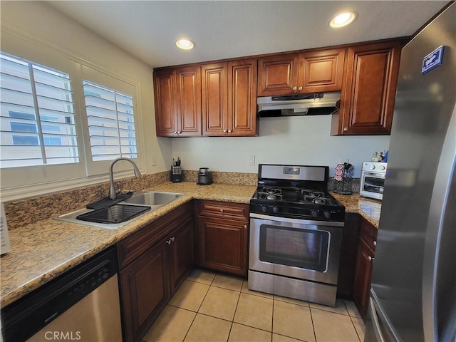 kitchen featuring light stone counters, light tile patterned flooring, sink, and stainless steel appliances