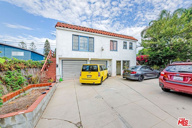 mediterranean / spanish-style home with a garage