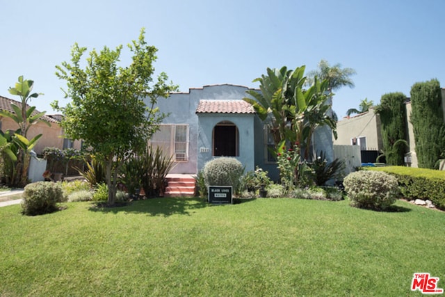 mediterranean / spanish-style home with a front lawn