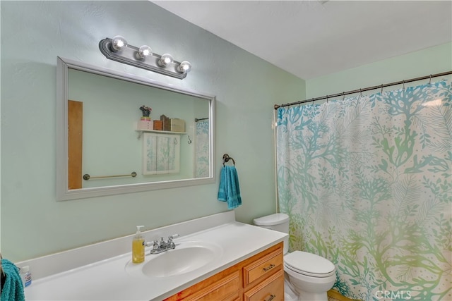 bathroom with walk in shower, vanity, and toilet