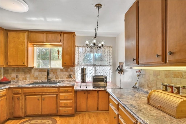 9226 La Porte Rd, Brownsville, CA 95919 - kitchen featuring brown cabinetry, backsplash, and a sink