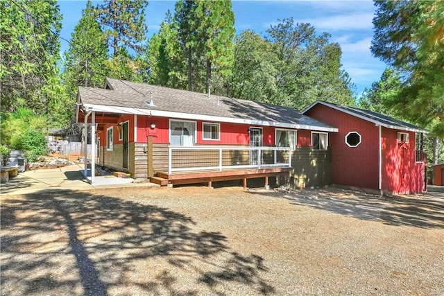 9226 La Porte Rd, Brownsville, CA 95919 - ranch-style home with a wooden deck, an outbuilding, and roof with shingles