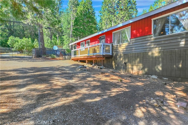 view of side of home featuring a wooden deck