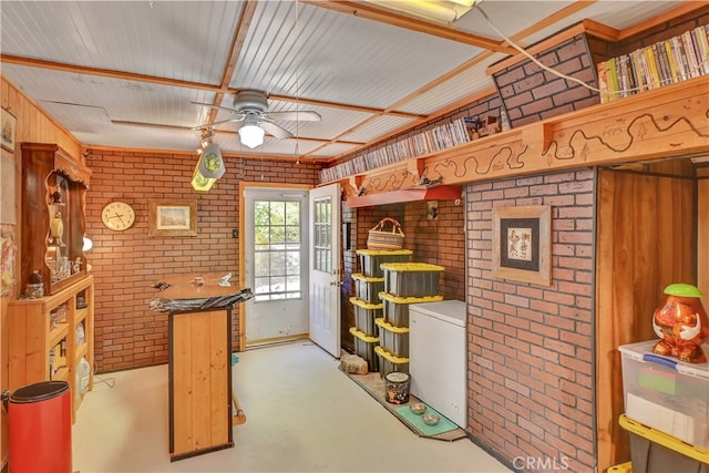 kitchen with brick wall, white refrigerator, and ceiling fan