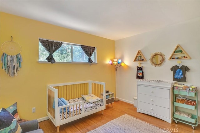 9226 La Porte Rd, Brownsville, CA 95919 - bedroom featuring a nursery area, baseboards, and wood finished floors