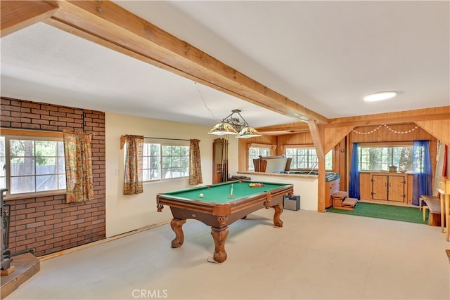 recreation room with billiards, wood walls, beam ceiling, and a wealth of natural light