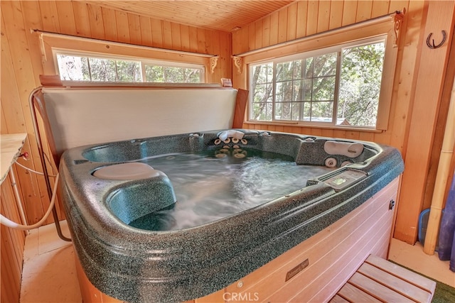 interior space featuring wood ceiling and wood walls