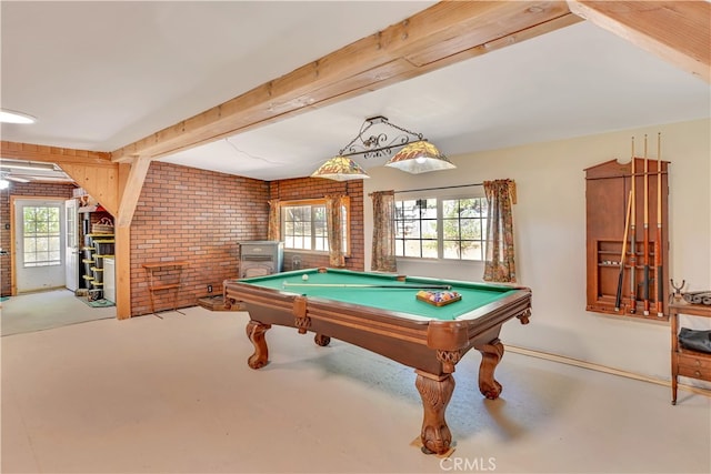 rec room featuring a wood stove, concrete flooring, brick wall, and billiards