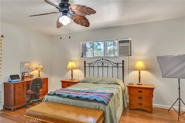 bedroom with light wood-type flooring, ceiling fan, and a wall mounted AC