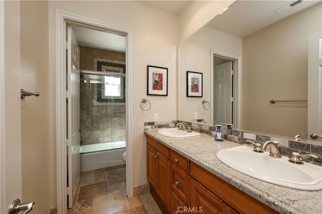 full bathroom with shower / bath combination with glass door, vanity, and toilet